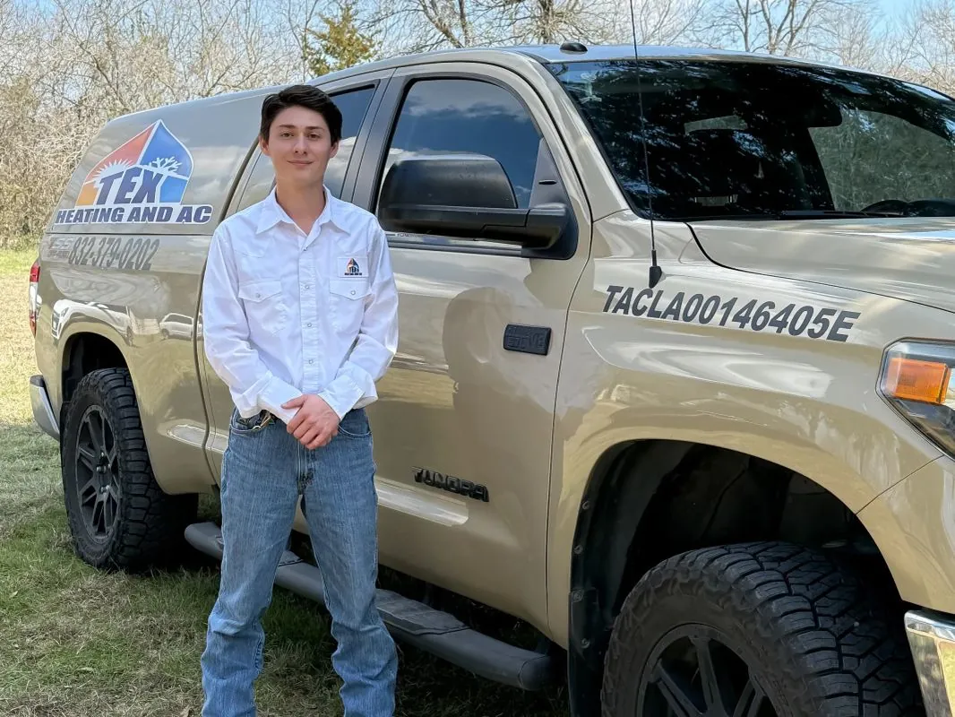 TEX Heating and AC technician next to the company service truck
